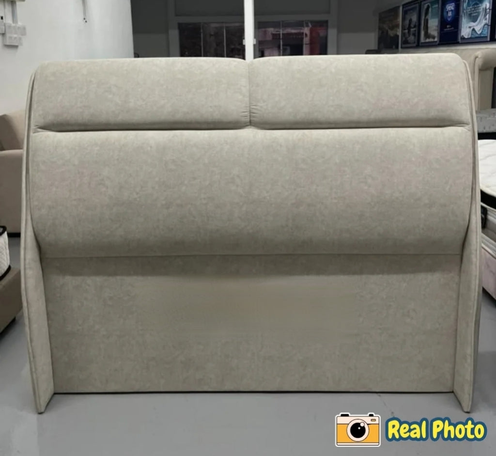 Beige upholstered headboard in a room setting