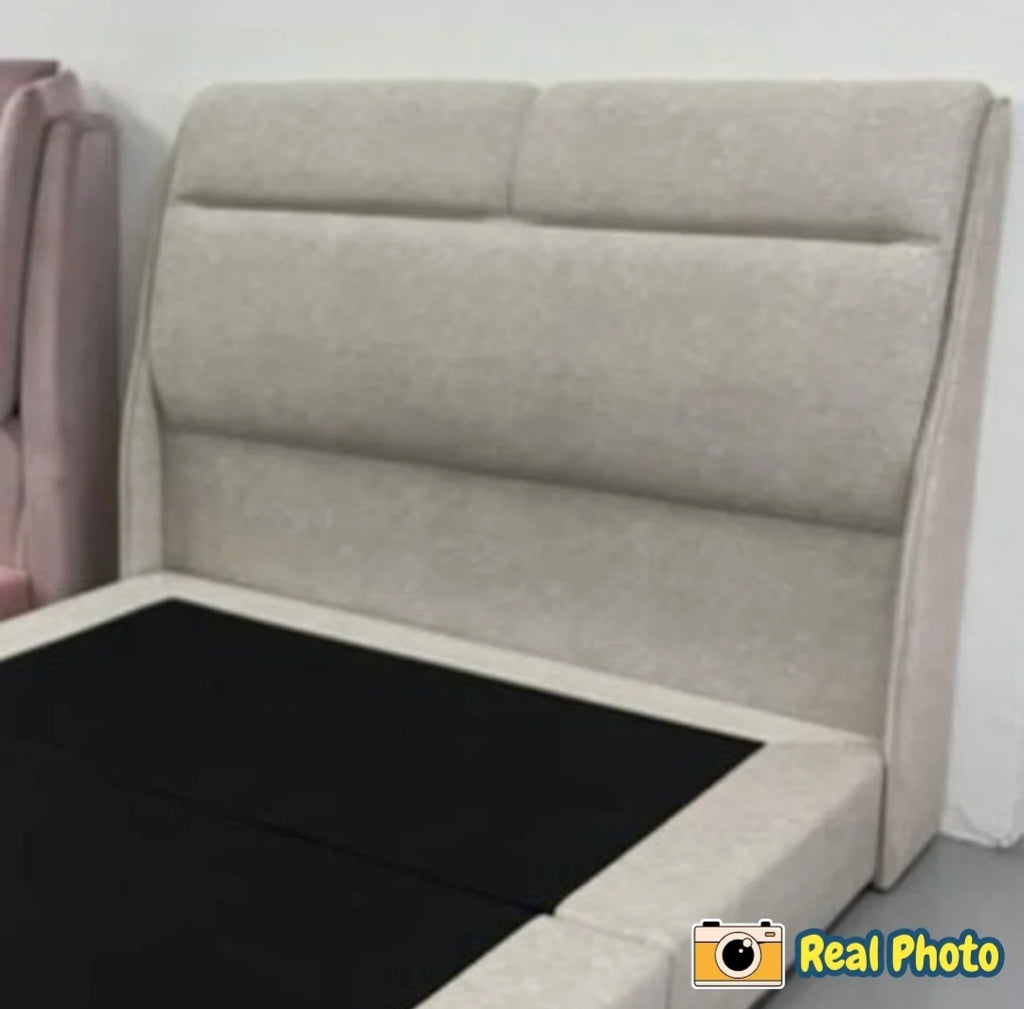 Beige upholstered headboard against a white wall